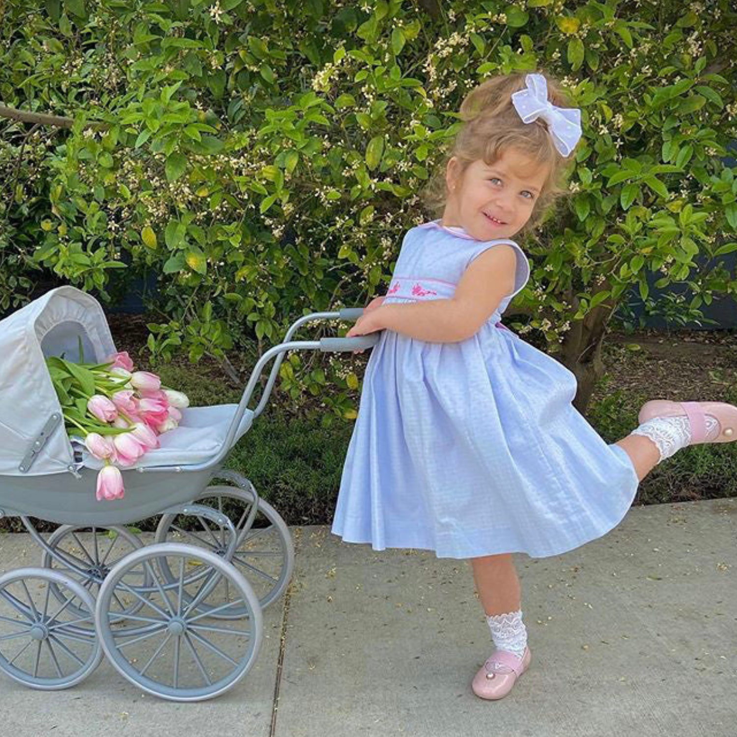 Charlotte sy Dimby classic timeless traditional smocked dresses for babies and girls handmade French style children clothing paris boutique twirling princess dress pastel blue and pink princess charlotte style