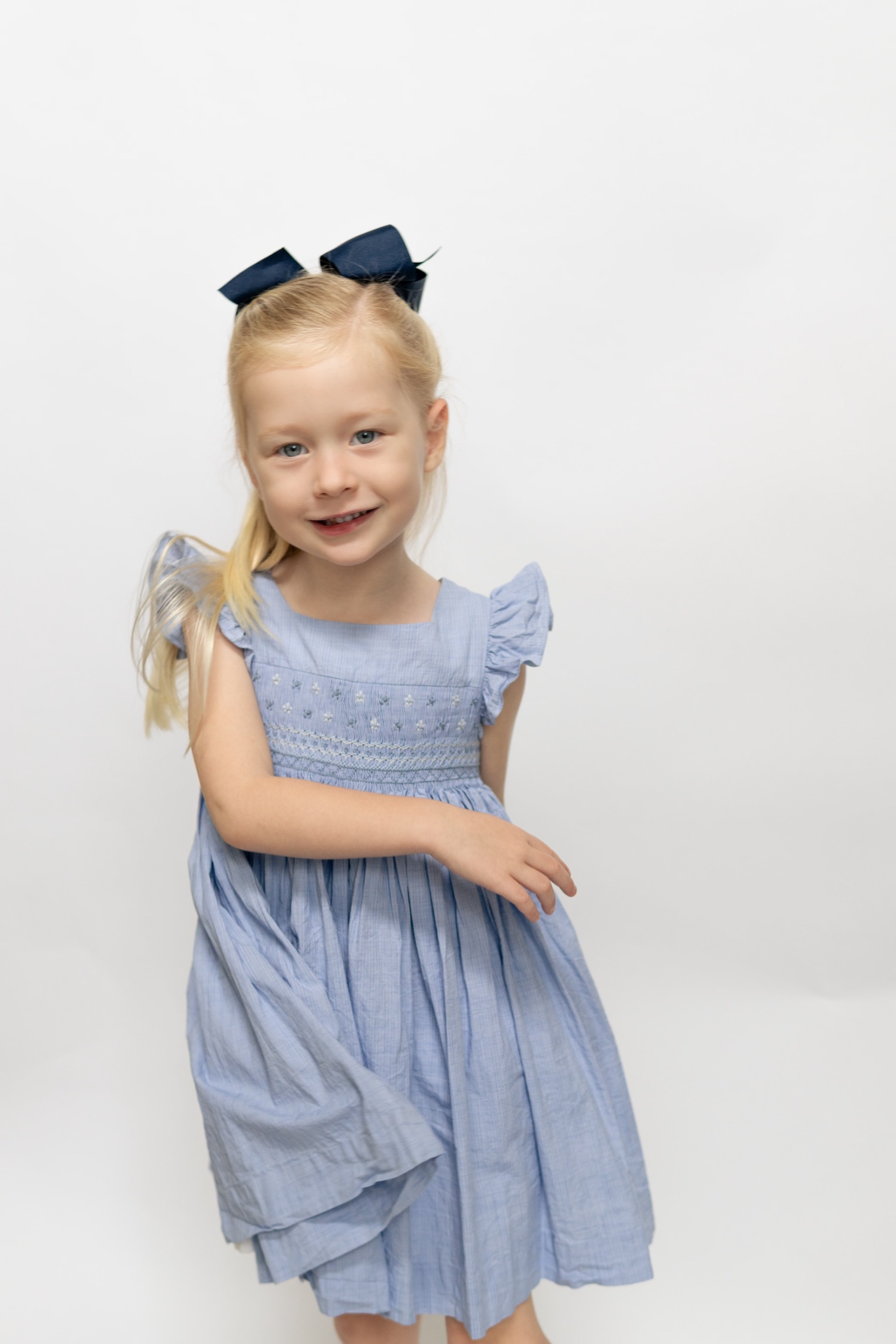 Charlotte sy Dimby classic timeless traditional smocked dresses for babies and girls handmade French style children clothing paris boutique pastel blue children photography heirloom twirl dress florida